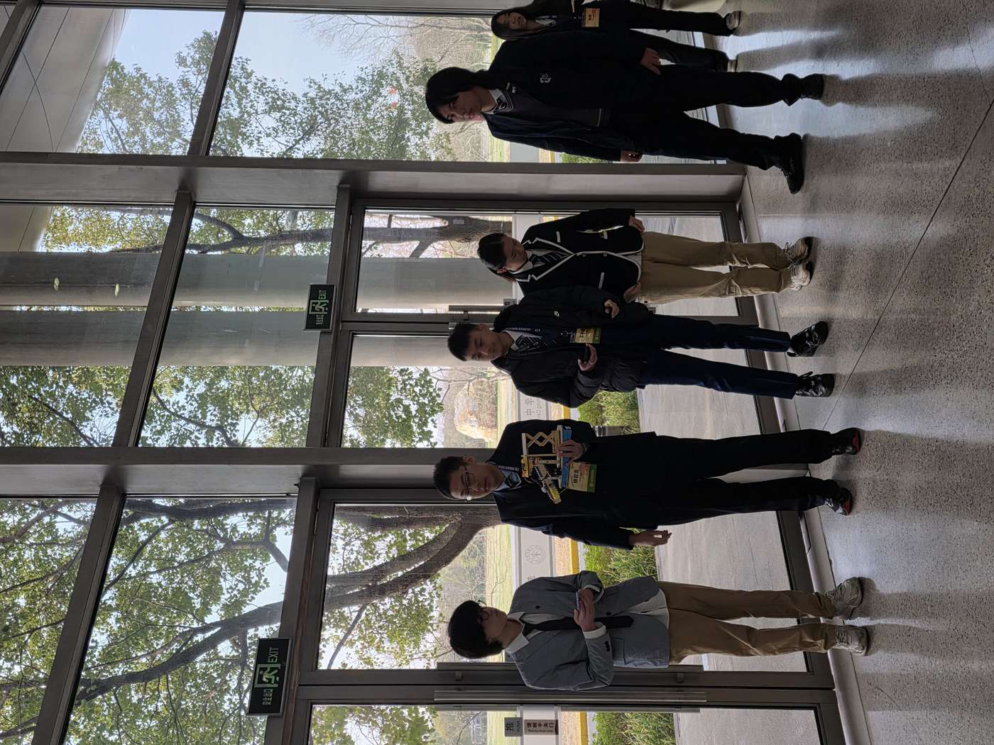 Team in suits with the robot model at the conference venue