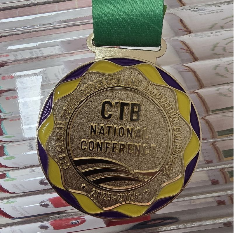 Close-up of the CTB National Conference medal with green ribbon