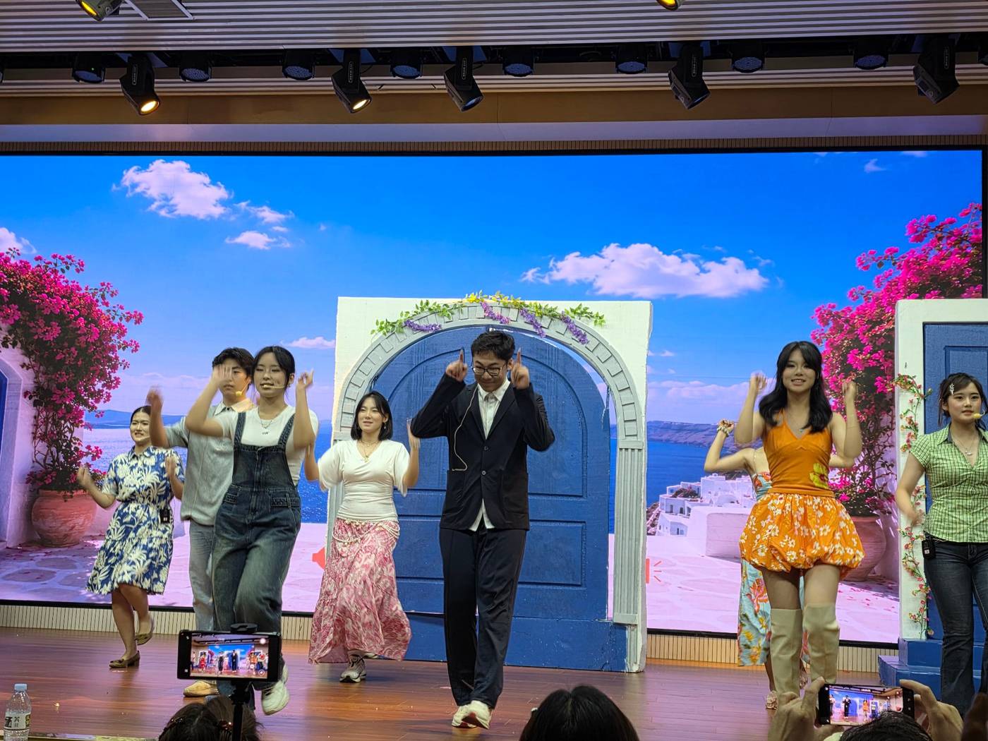 Dancing at center stage in a black suit in the Mamma Mia school musical
