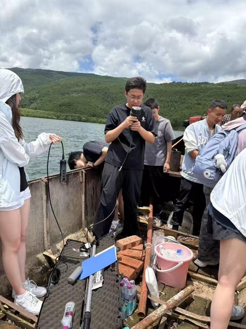Operating a water-quality sonde on a research boat at Erhai Lake