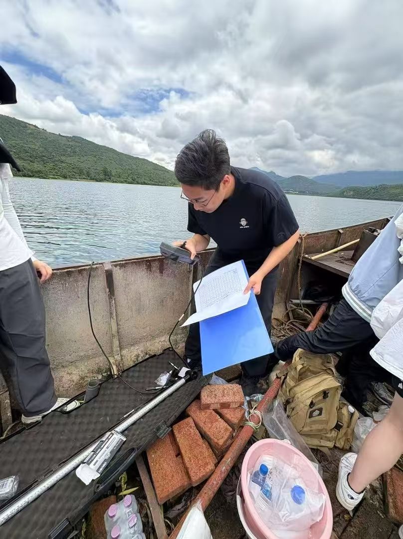 Recording field data on a clipboard aboard the research boat