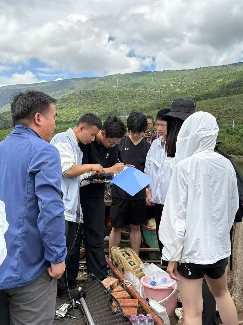 Research team discussing readings together on the boat