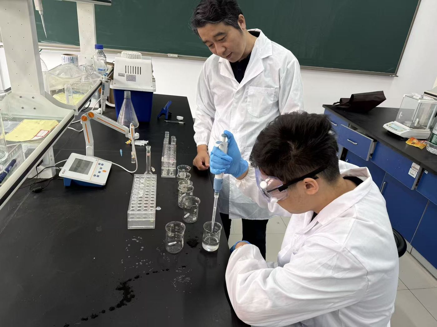 Pipetting samples under the guidance of Professor Cao